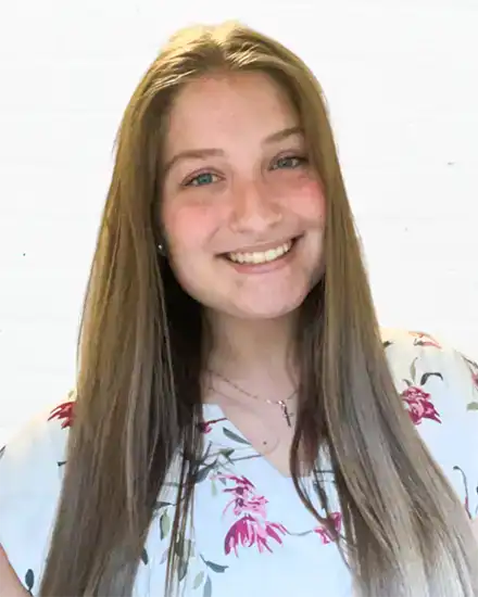 Teen girl smiling, practicing communication skills coaching for teens and adults.
