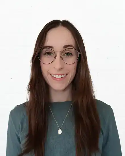 Woman with glasses smiling, promoting effective communication services.