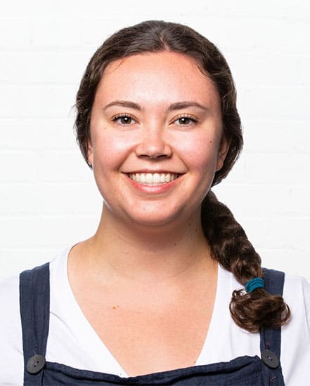 Young woman smiling, communication skills, friendly professional portrait.