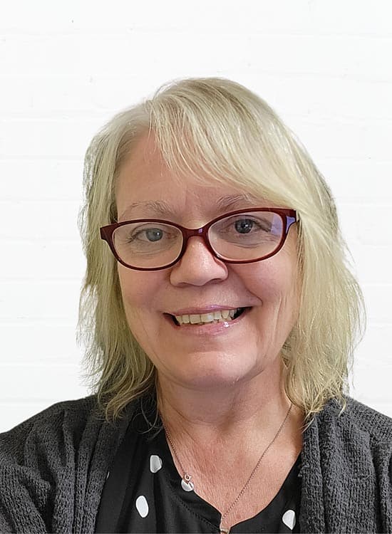 Professional woman smiling, communication skills expert, headshot.