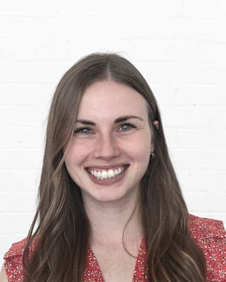 Woman smiling confidently, communication skills coaching, professional development.